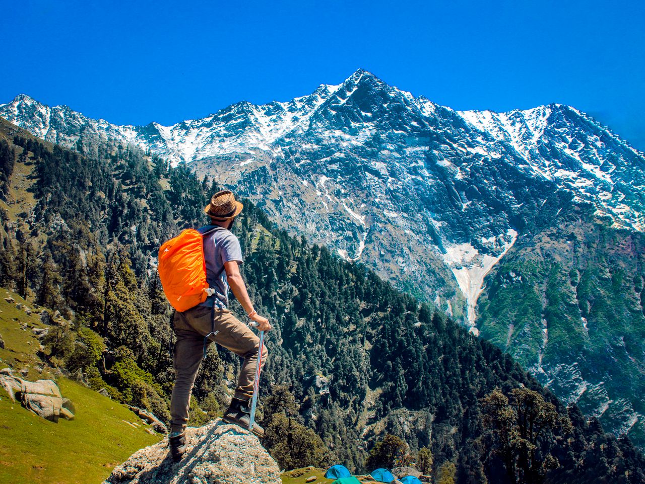 Mastering the First Impression: Your intriguing post title goes here Man exploring breathtaking mountain scenery with snow-capped peaks under a clear blue sky.